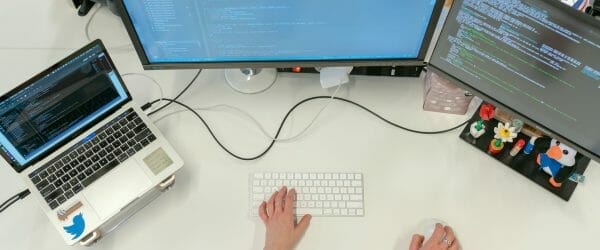 female software engineer coding on computer