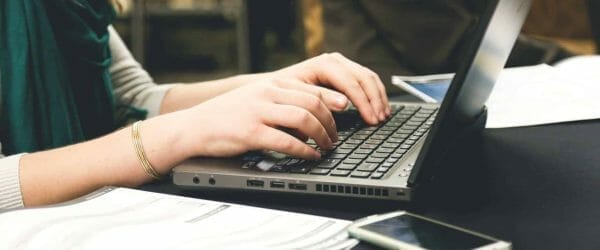 woman typing on laptop