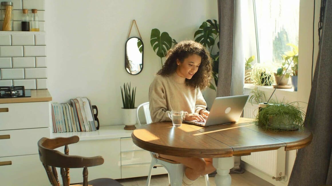 A women working on laptop for her small business. Article: How CRM can help your small business in 2022?