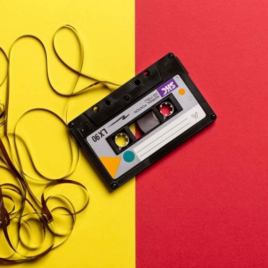 black cassette tape on top of red and yellow surface