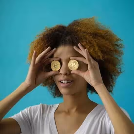 woman holding two coins