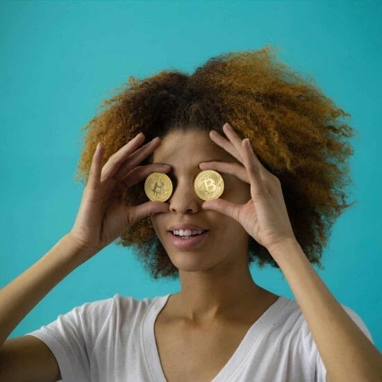 woman holding two coins