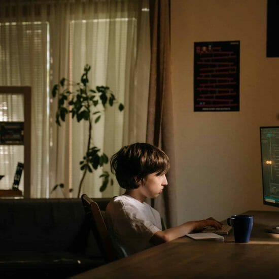 boy in white shirt sitting on chair