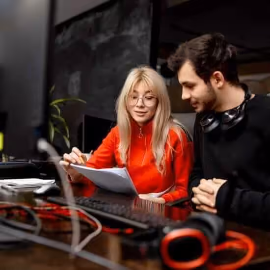 two colleagues are discussing issues modern office man woman colleagues are sitting table with computer business plan