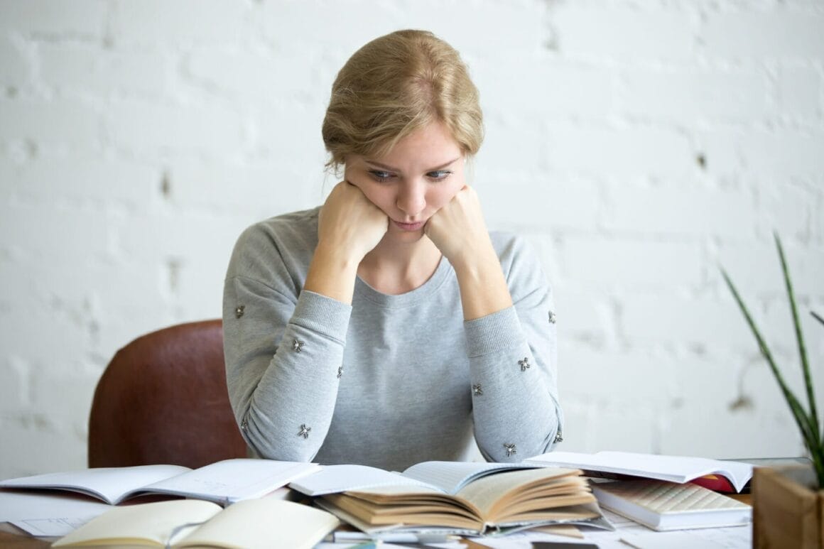 portrait tired student woman desk