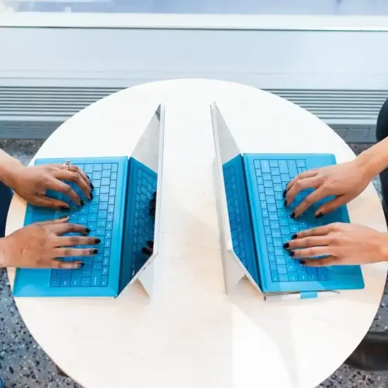 two people working on laptops