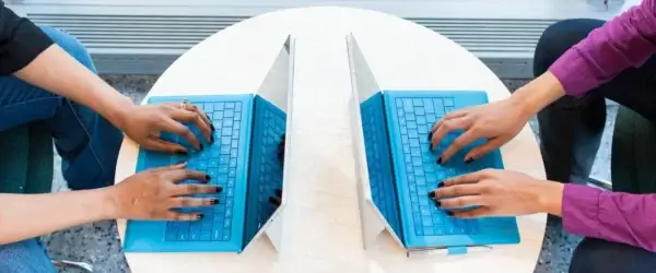 two people working on laptops