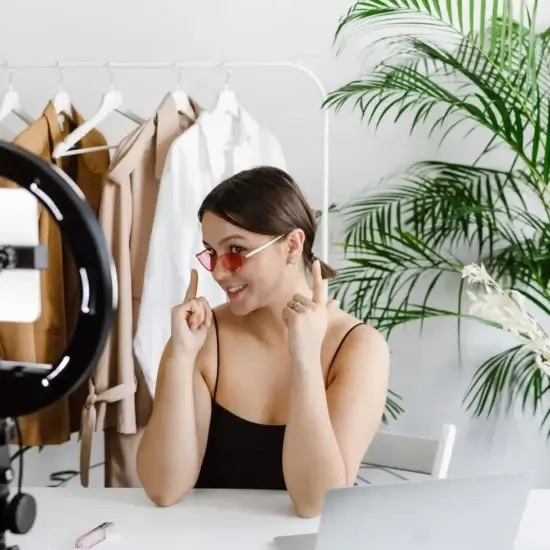 a woman showing her sunglasses to a video recording