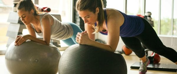 a group of women working out on exercise balls