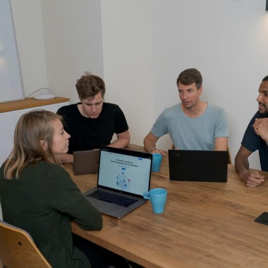 a group of people discussing saas or custom development