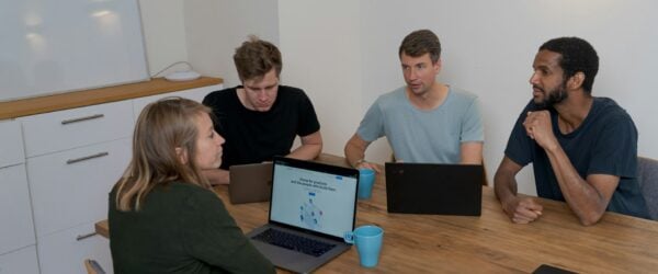 a group of people discussing saas or custom development