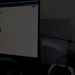 PlayStation console next to computer monitor