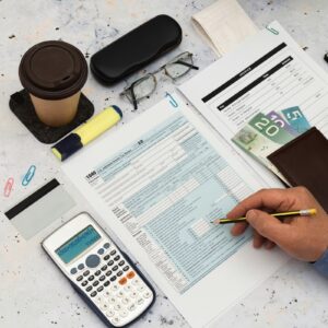 Accounts Receivable Banner.jpg Calculating finances with documents and coffee