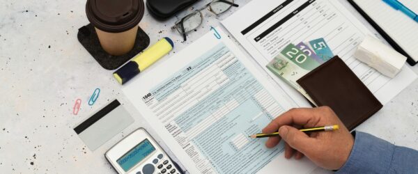 Accounts Receivable Banner.jpg Calculating finances with documents and coffee